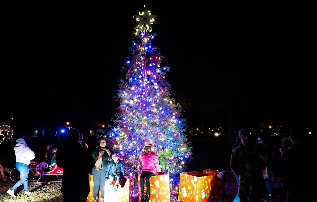 Members from the Fort Eustis community enjoy the holiday tree with their friends and families at Joint Base Langley-Eustis, Virginia, Dec. 2, 2022.