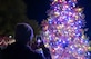 A member of the Fort Eustis community takes a photo of the holiday tree during the annual tree lighting ceremony at Joint Base Langley-Eustis, Virginia, Dec. 2, 2022.