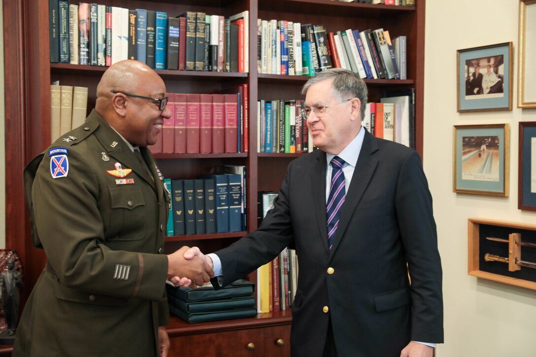 Maj. Gen. Isaac Johnson, Jr., commanding general, U.S. Army Civil Affairs and Psychological Operations Command (Airborne), and Ambassador David M. Satterfield, director, Rice University’s Baker Institute for Public Policy, shake hands after signing a Memorandum of Understanding (MOU) November 28, 2022. The MOU is aimed at providing additional training opportunities to the U.S. Army Reserve’s Military Government Specialists (38G). (US Army Reserve photo by Sgt. 1st Class Lisa M Litchfield)
