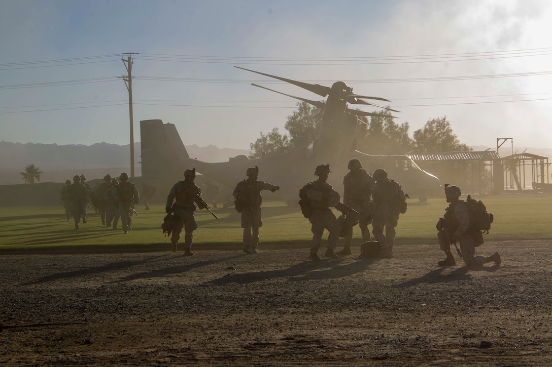 U.S. Marine Corps infantrymen with 2nd Battalion, 7th Marine Regiment, provide security around an MV-22B Osprey aircraft during a noncombatant evacuation operation (NEO) exercise as part of Weapons and Tactics Instructor course 1-23 at Marine Corps Air Ground Combat Center, Twentynine Palms, California, Oct. 27, 2022. The NEO simulated real-life scenarios for Marines to practice the evacuation of noncombatants from potentially dangerous areas. (U.S. Marine Corps photo by Lance Cpl. Jacquilyn Davis)