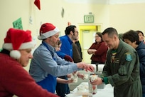 Santa, Mrs. Claus and more than three dozen elves from the Alaska Air and Army National Guard partnered with the Salvation Army to deliver 1,420 pounds of gifts, hygiene supplies, and books to 191 children in Nuiqsut, Alaska, Nov. 29, 2022. Celebrating 67 years of Operation Santa Claus, a 176th Wing, Alaska Air National Guard HC-130J Combat King II aircraft served as Santa's sleigh, delivering tidings of good cheer to the North Slope Borough community. (Alaska Air National Guard photo by Senior Airman Emily Batchelor)