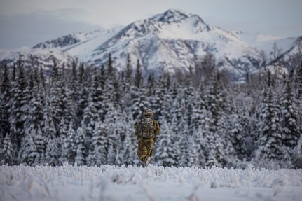 Alaska Army National Guard Infantryman assigned to Avalanche Company, 1st Battalion, 297th Infantry Regiment, conducts military tactical movements (bounding overwatch) while engaging with opposing forces during a training exercise near Joint Base Elmendorf-Richardson Dec. 3, 2022. The exercise was aimed at enhancing the unit’s combat readiness and to evaluate proficiency in an arctic environment. (Army National Guard photo by Spc. Bradford Jackson, 134th Public Affairs Detachment)