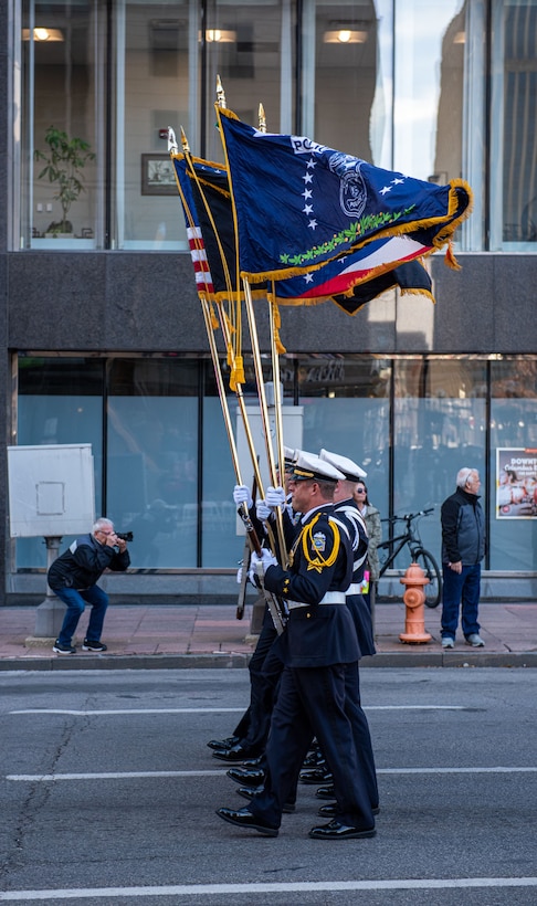 The four person Columbus Police Color Guard marches down the street.