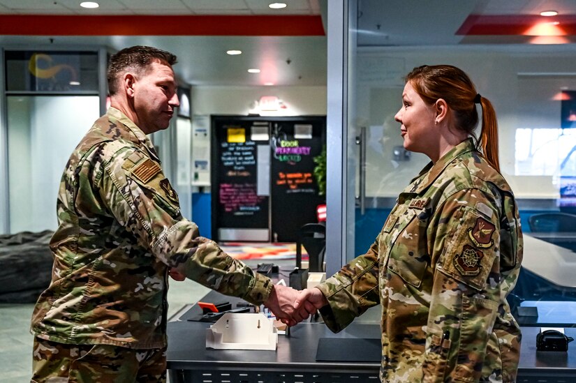 Chief Master Sgt. David Kolcun, 305th Air Mobility Wing command chief, coins Tech. Sgt. Crystal Wiggins, 305th Air Mobility Wing innovation lab subject matter expert, at Joint Base McGuire-Dix-Lakehurst, N.J. on Dec. 5, 2022. The 305th Innovation Lab was acknowledged for its numerous contributions to the Joint Base and Air Mobility Command.