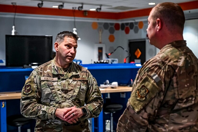 Chief Master Sgt. David Kolcun, 305th Air Mobility Wing command chief, speaks with Master Sgt. Steven Hoare, 305th Air Mobility Wing innovation lab superintendent, at Joint Base McGuire-Dix-Lakehurst, N.J. on Dec. 5, 2022. The 305th Innovation Lab was acknowledged for its numerous contributions to the Joint Base and Air Mobility Command.