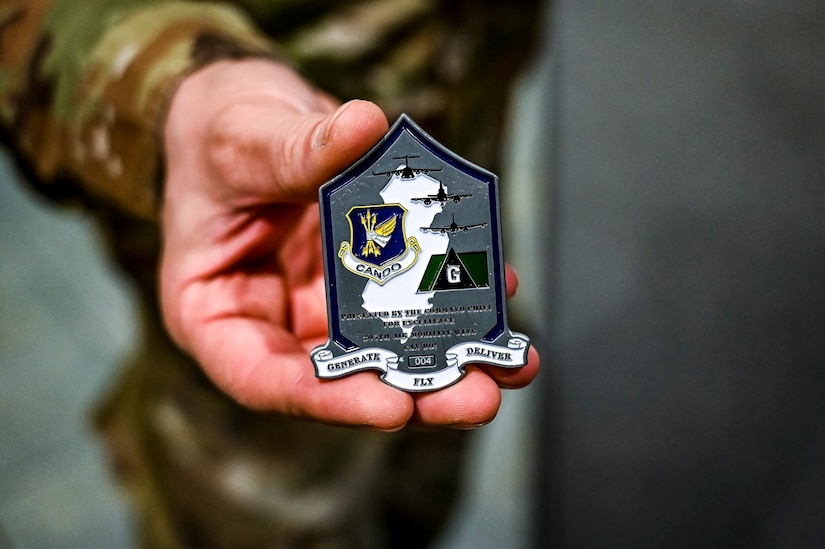 U.S. Air Force Staff Sgt. David Babel, 305th Air Mobility Wing innovation lab subject matter expert, displays a coin at Joint Base McGuire-Dix-Lakehurst, N.J. on Dec. 5, 2022. The 305th Innovation Lab was acknowledged for its numerous contributions to the Joint Base and Air Mobility Command.