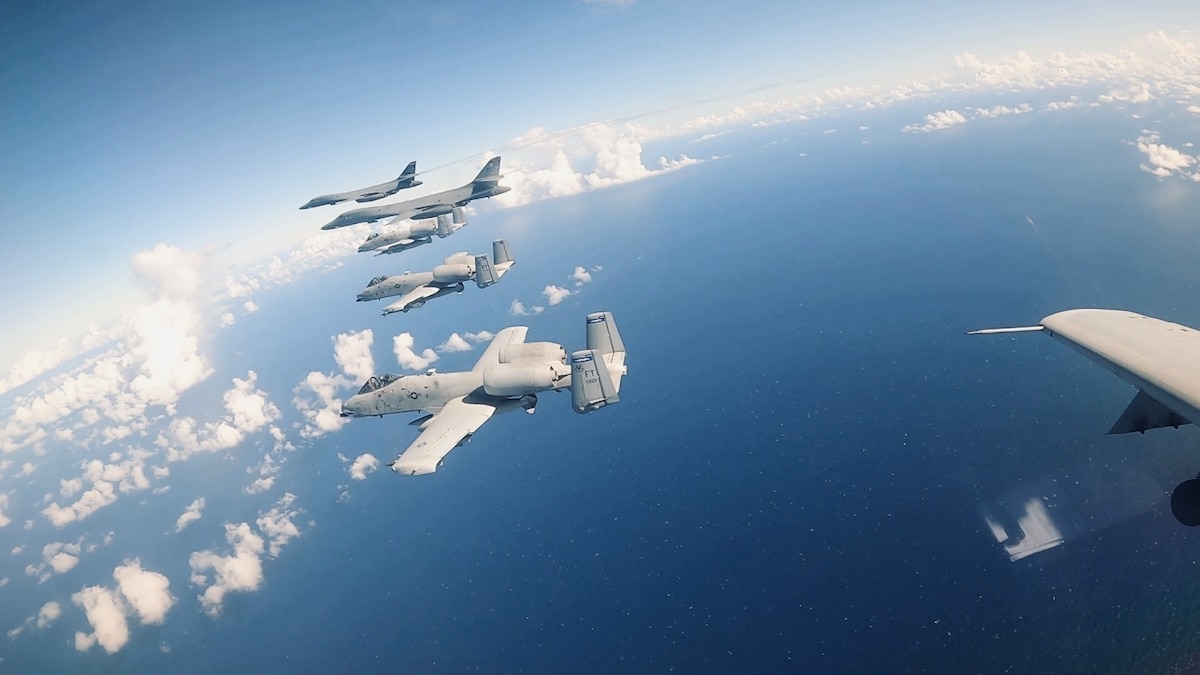 B-1B Lancer and A-10C Thunderbolt II aircraft fly above the Philippine Sea