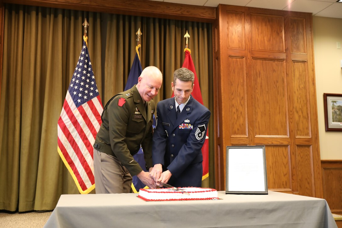 U.S. Army Maj. Gen. Mark Schindler, left, the Adjutant General of Pennsylvania, and Air Force Master Sgt. John McDermott cut a commemorative cake during a ceremony in Edward Martin Hall observing the Pennsylvania National Guard's 275th birthday.