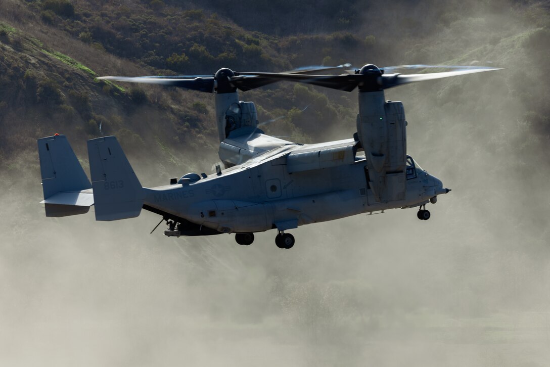 A U.S. Marine MV-22 Osprey tiltrotor aircraft with Marine Medium Tiltrotor Squadron 164, Marine Aircraft Group 39, 3rd Marine Aircraft Wing, prepares to land during an air assault as part of Steel Knight 23 at Marine Corps Base Camp Pendleton, California, Dec. 5, 2022. Steel Knight is an annual combined arms live-fire exercise which ensures 1st MARDIV is optimized for naval expeditionary warfare in contested spaces, and is purpose-built to facilitate future operations afloat and ashore. (U.S. Marine Corps photo by Lance Cpl. Barton)