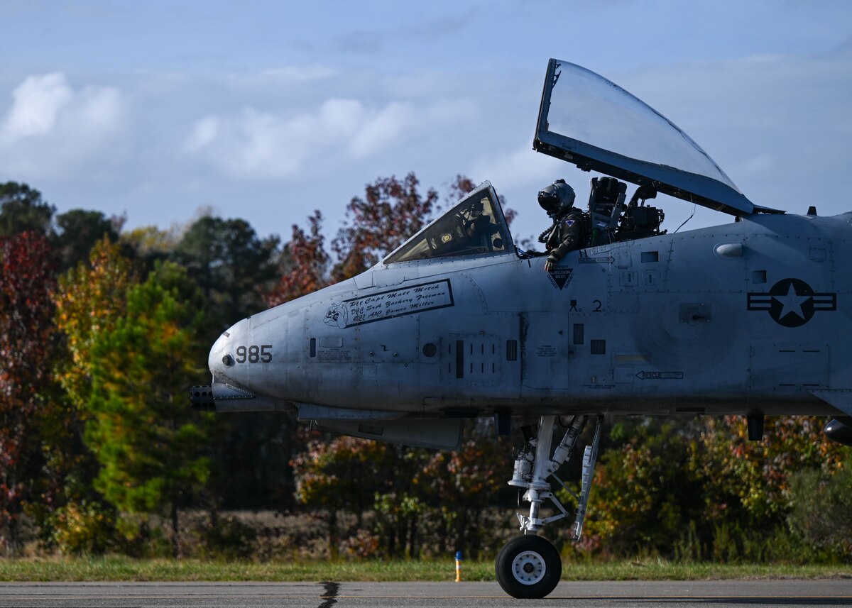 A photo of a military aircraft taxing on a runway.