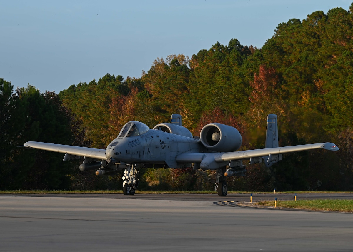 A photo of a military aircraft taxing on a runway.