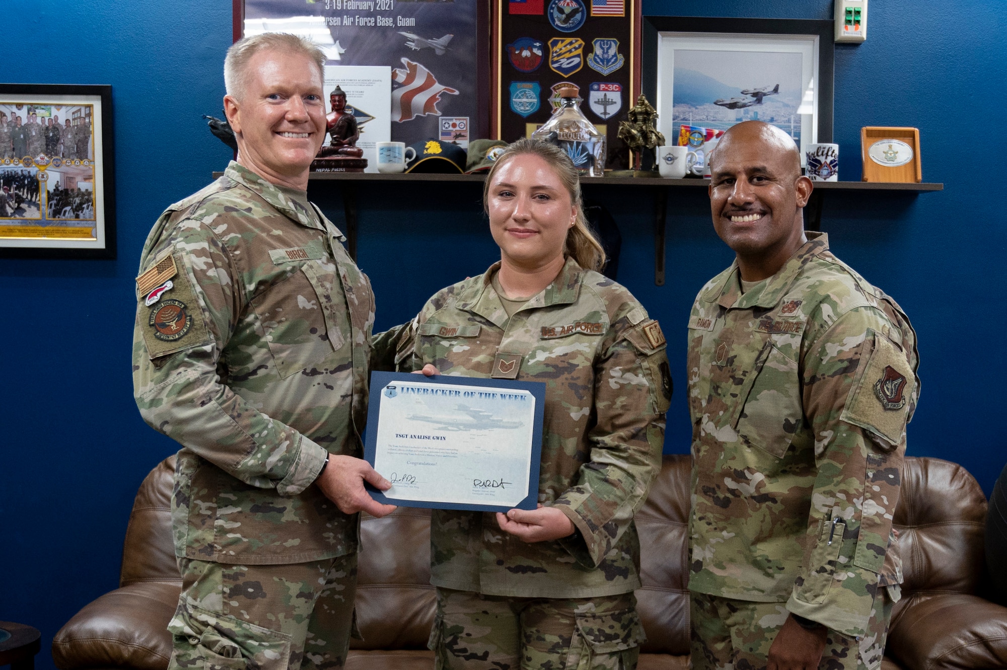 U.S. Air Force Tech. Sgt. Analise Gwin, the noncommissioned officer in charge of the commander’s support staff assigned to the 36th Contingency Response Support Squadron, receives the Linebacker of the Week Award from U.S. Air Force Brig. Gen Paul Birch, the 36th Wing commander, and U.S. Air Force Chief Master Sgt. Jose Ramon, the senior enlisted leader of the 36th Maintenance Group, at Andersen Air Force Base, Guam, Dec. 2, 2022. The Team Andersen Linebacker of the Week recognizes outstanding enlisted, officer, civilian and total force personnel who have had an impact on achieving Team Andersen’s mission, vision and priorities. (U.S. Air Force photo by Airman 1st Class Emily Saxton)