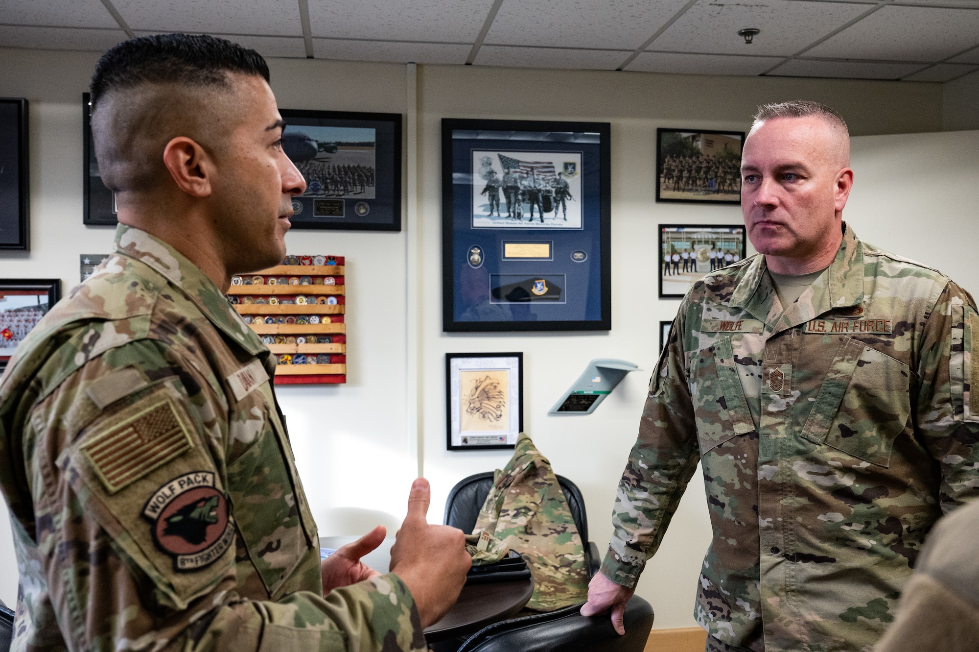 Chief Master Sgt. Carlos Damian (left), 8th Fighter Wing command chief, speaks with Chief Master Sgt. David R. Wolfe, Pacific Air Forces Command chief master sergeant, at Kunsan Air Base, Republic of Korea, Dec. 5, 2022. During his visit with Kunsan’s Wolf Chief, Wolfe spoke about future training and readiness opportunities that would further develop the installation’s combat-ready Airmen who are the foundation of Pacific stability and security. (U.S. Air Force photo by Staff Sgt. Sadie Colbert)