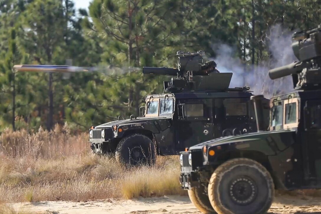 Soldiers fire a missile in a field.