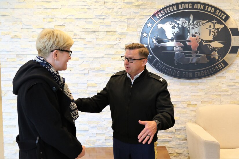 U.S. Army Col. Randy Lutz, commander of the Eastern Army National Guard Aviation Training Site, welcomes the Prime Minister of Lithuania, Ingrida Šimonytė, to Fort Indiantown Gap's Aviation Maintenance Instruction Building to tour the facility and learn more about the Pennsylvania National Guard’s partnership with the Lithuanian Armed Forces.