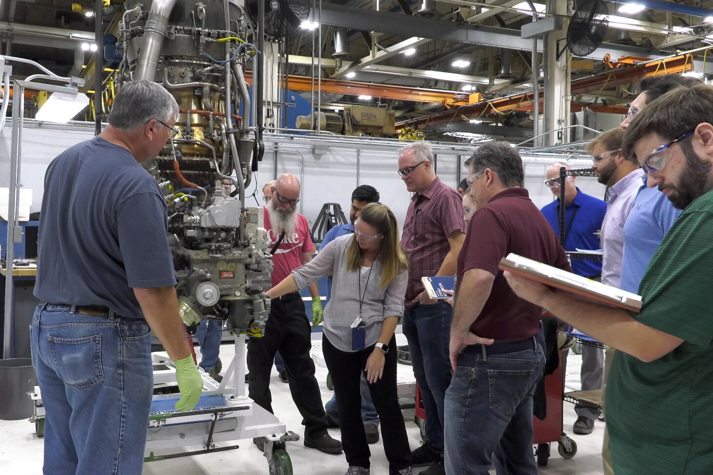 Engineers watch T408 engine disassembly