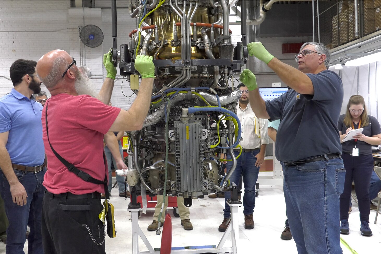 Mechanics disassemble T408 engine