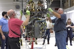 Fleet Readiness Center East (FRCE) engine mechanics Travis Barclay, left, and Mark Schexnayder work on the depot’s first disassembly of a T408 engine, which powers the CH-53K King Stallion helicopter.  Maintenance, repair and overhaul of the Marine Corps’ new heavy-lift helicopter and its components will soon represent a significant portion of FRCE’s operations.