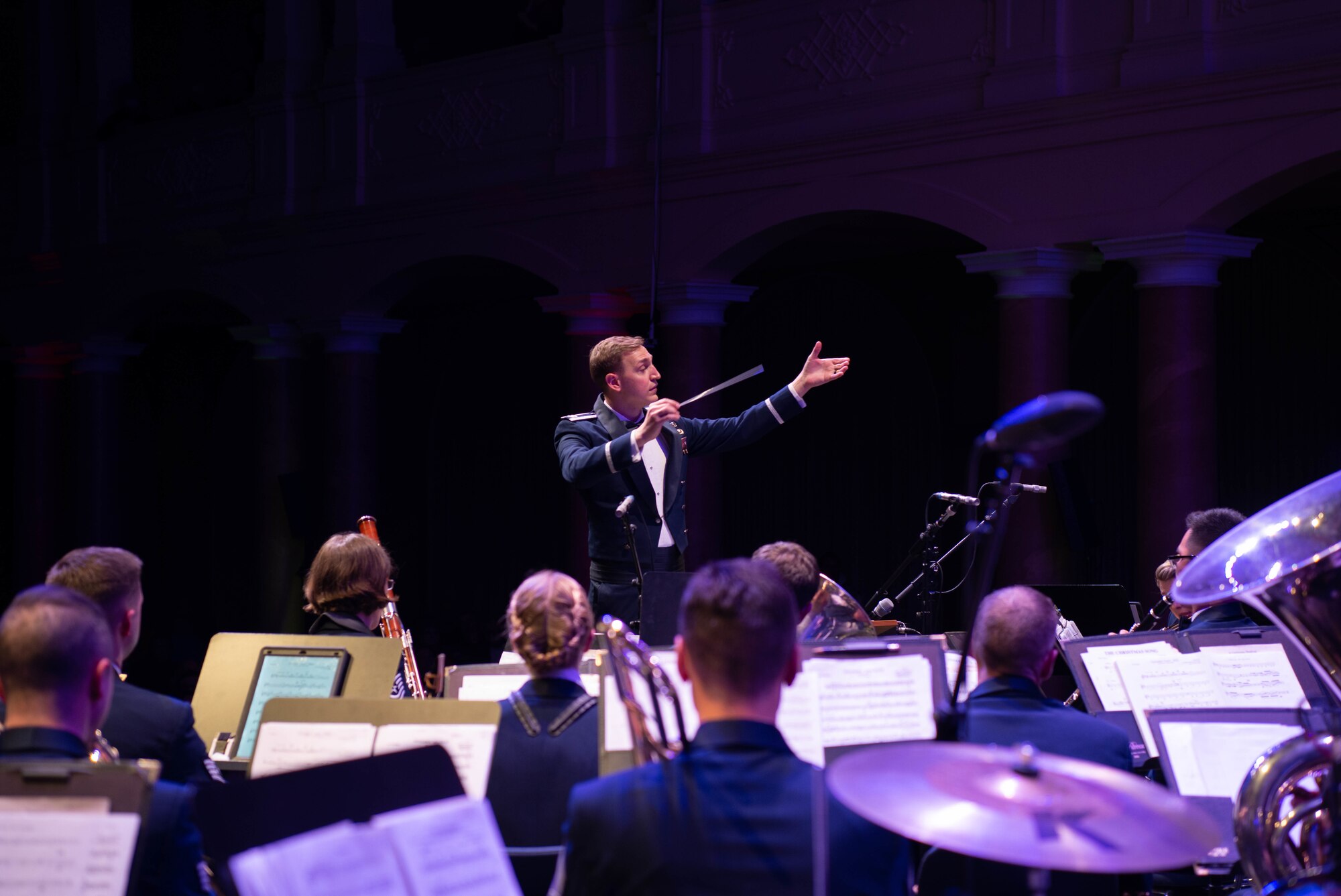 Conductor conducts band during holiday concert