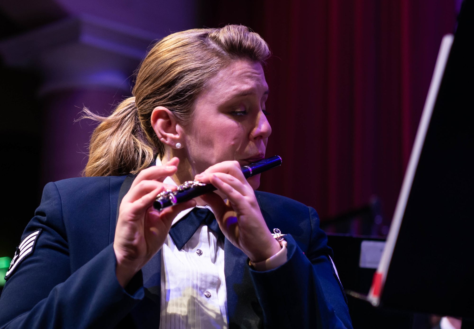 Musician plays piccolo during holiday concert