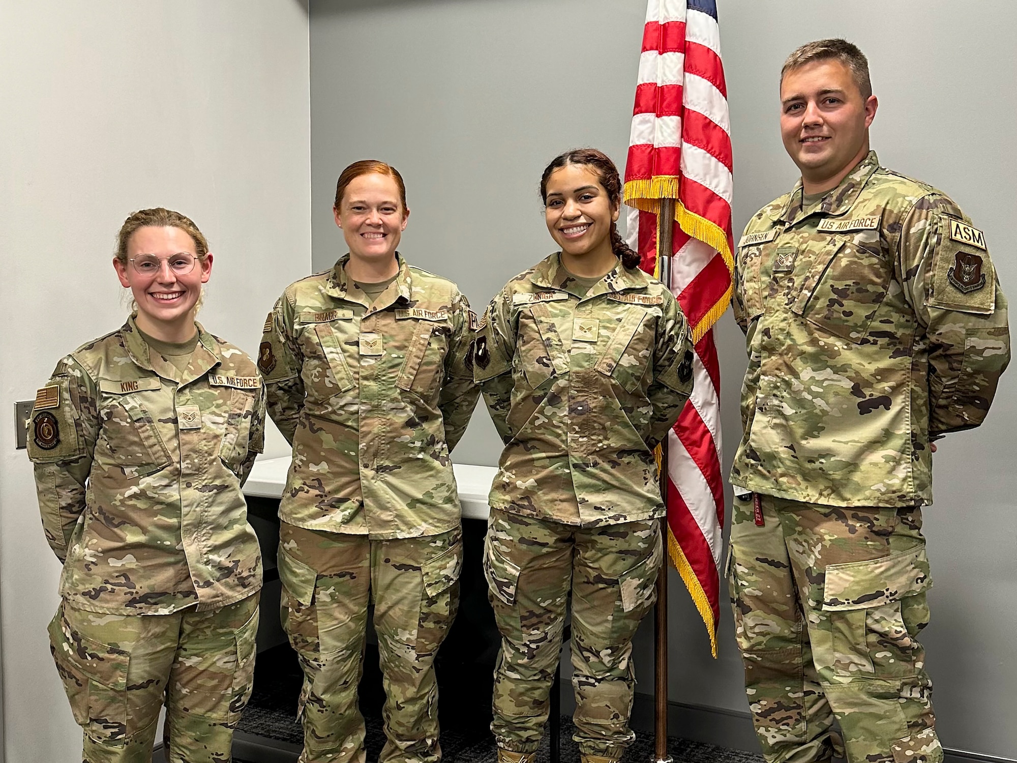 Photo of Airmen standing and smiling