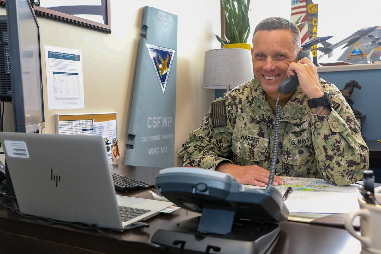 Cmdr. Ronnie Harper, Maintenance Operation Center (MOC) Aircraft on Ground (AOG) director, poses for a photo in his office, July 26.