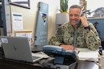 Cmdr. Ronnie Harper, Maintenance Operation Center (MOC) Aircraft on Ground (AOG) director, poses for a photo in his office, July 26.