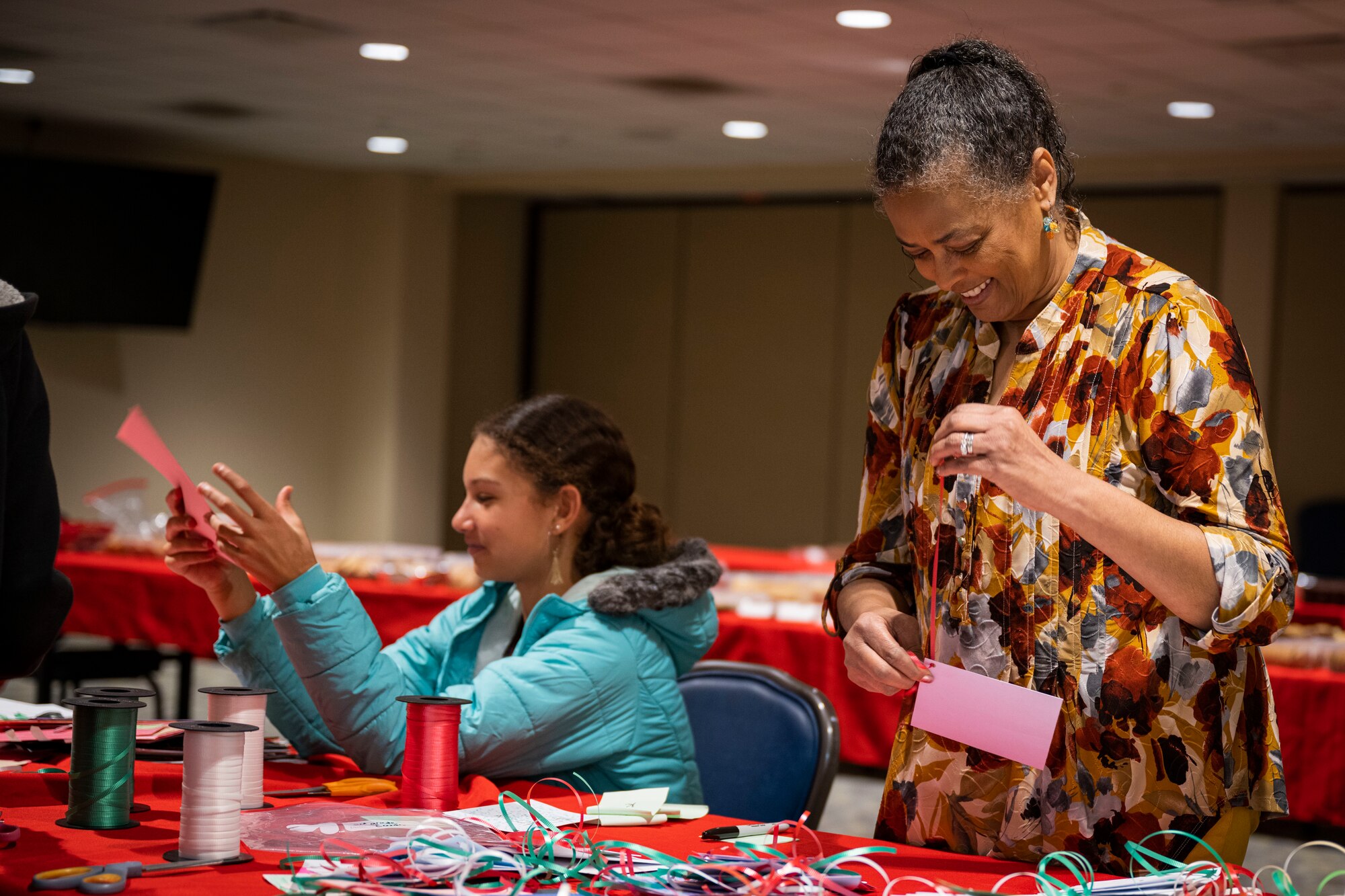 Members from the Goldsboro community prepare cards for dorm Airmen as part of the annual cookie drive at Seymour Johnson Air Force Base, North Carolina, Dec. 4, 2022. The cards were donated, along with bags of cookies, to give to dorm Airmen this holiday season.