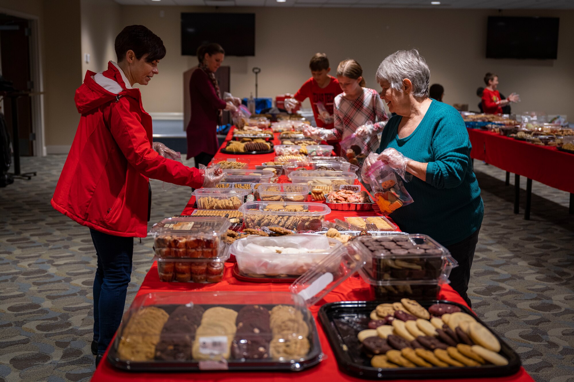 Members from the Goldsboro community prepare cookie bags for dorm Airmen as part of the annual cookie drive at Seymour Johnson Air Force Base, North Carolina, Dec. 4, 2022. The cookies were donated by members of the local community and delivered to 4th Fighter Wing dorm Airmen Dec. 5.