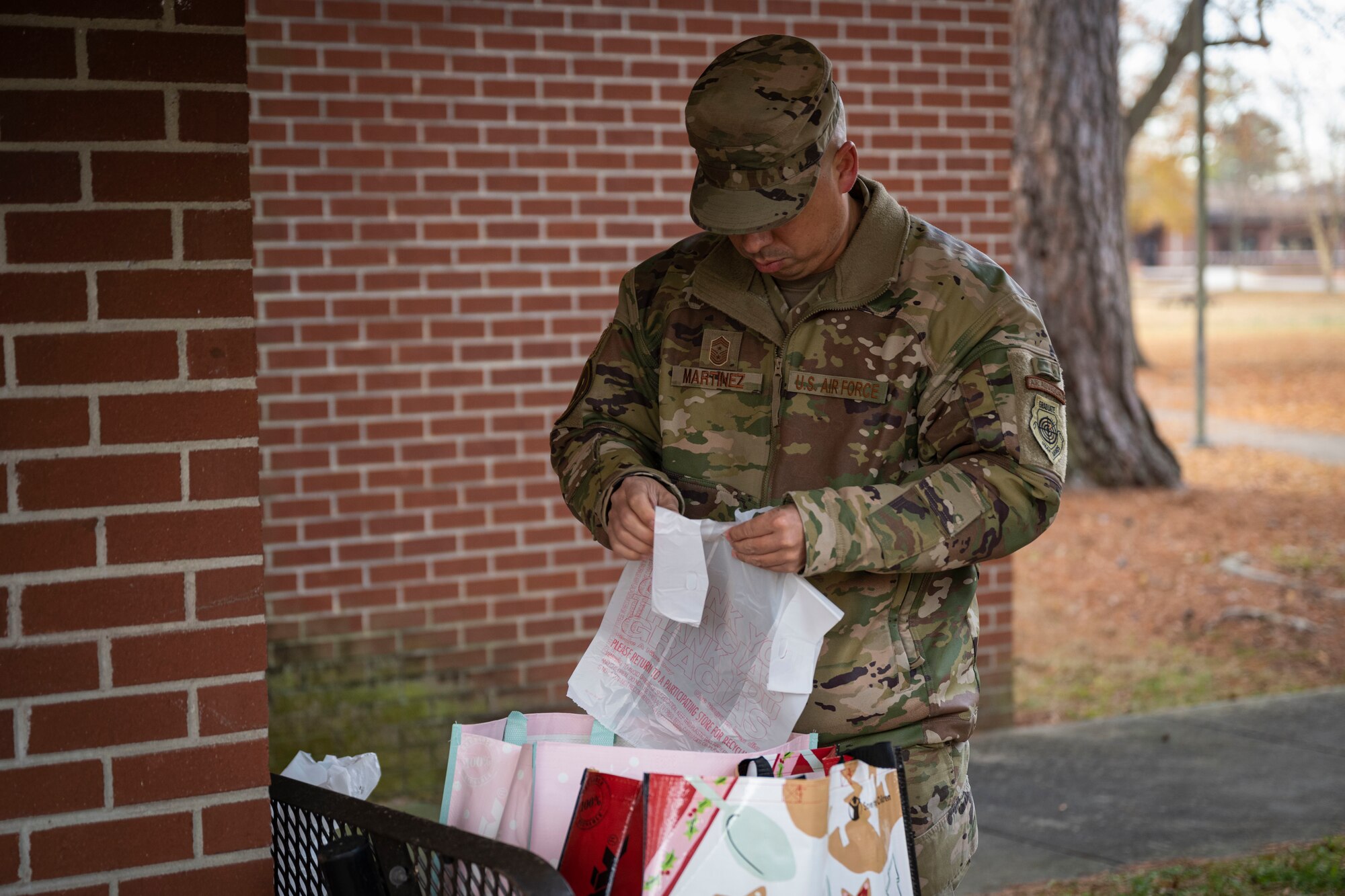 Chief Master Sgt. Peter Martinez, 4th Fighter Wing command chief, prepares cookie bags for dorm Airmen as part of the annual cookie drive at Seymour Johnson Air Force Base, North Carolina, Dec. 5, 2022. The cookies were donated by members of the Goldsboro community and the 4th FW.
