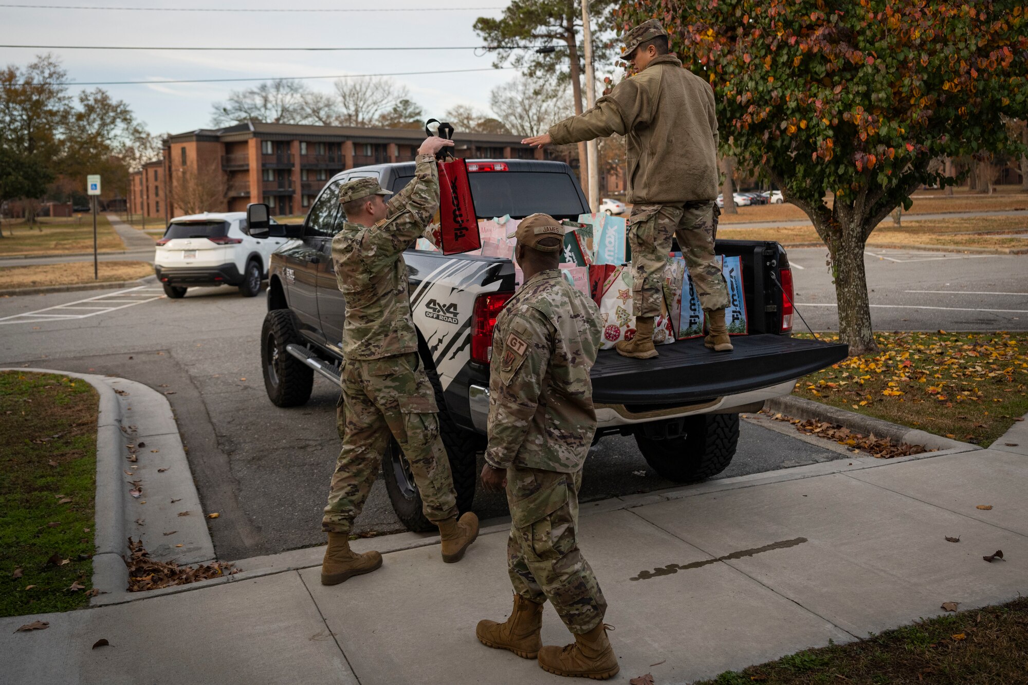 4th Fighter Wing first sergeants load bags of cookies into a truck as part of the annual cookie drive at Seymour Johnson Air Force Base, North Carolina, Dec. 5, 2022. The drive was held to try to bring holiday cheer to dorm Airmen.