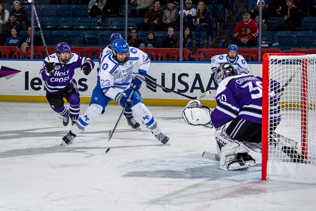 A hockey player prepares a shot on goal.