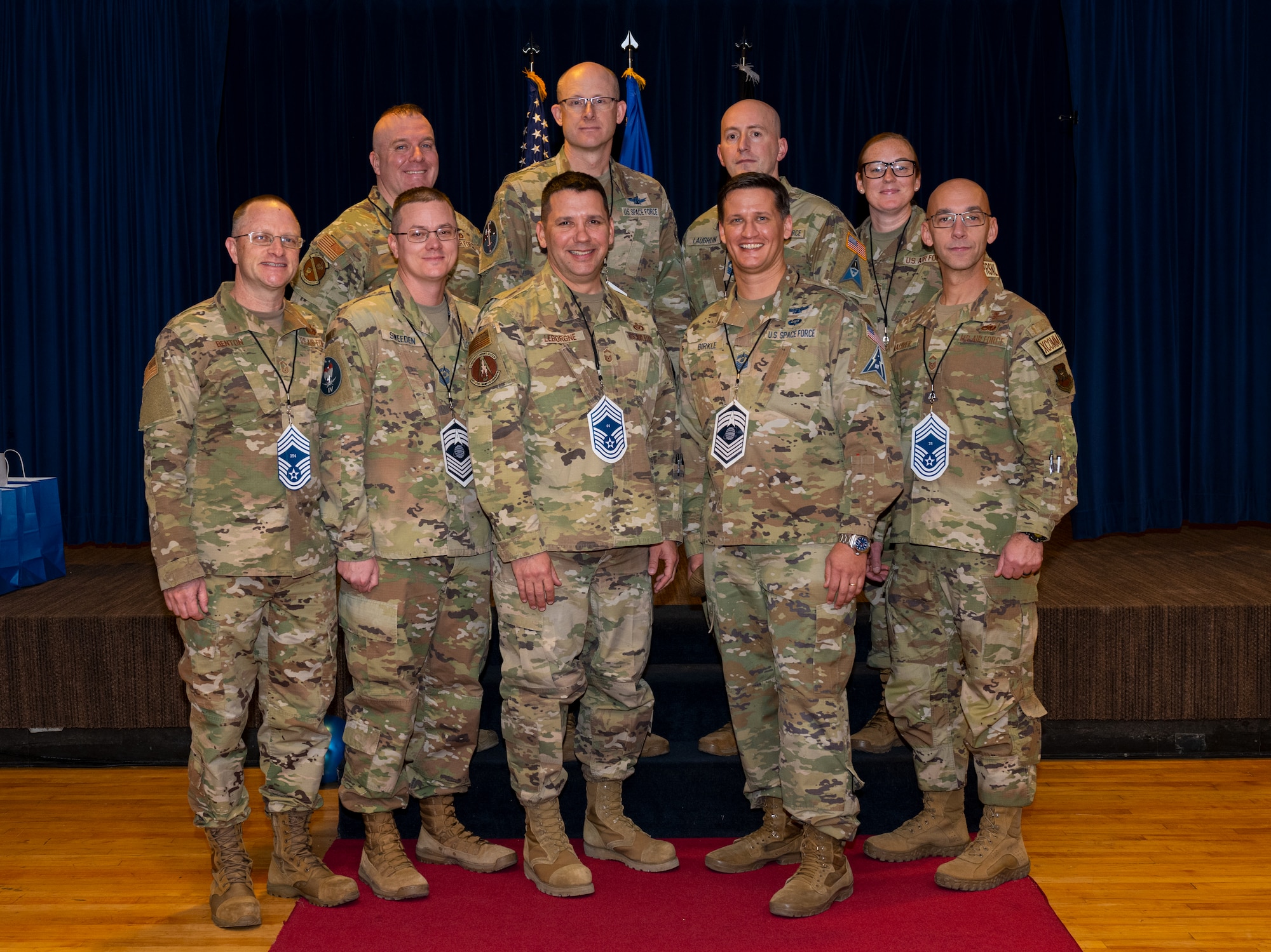 Military members posing for a photo during a promotion ceremony