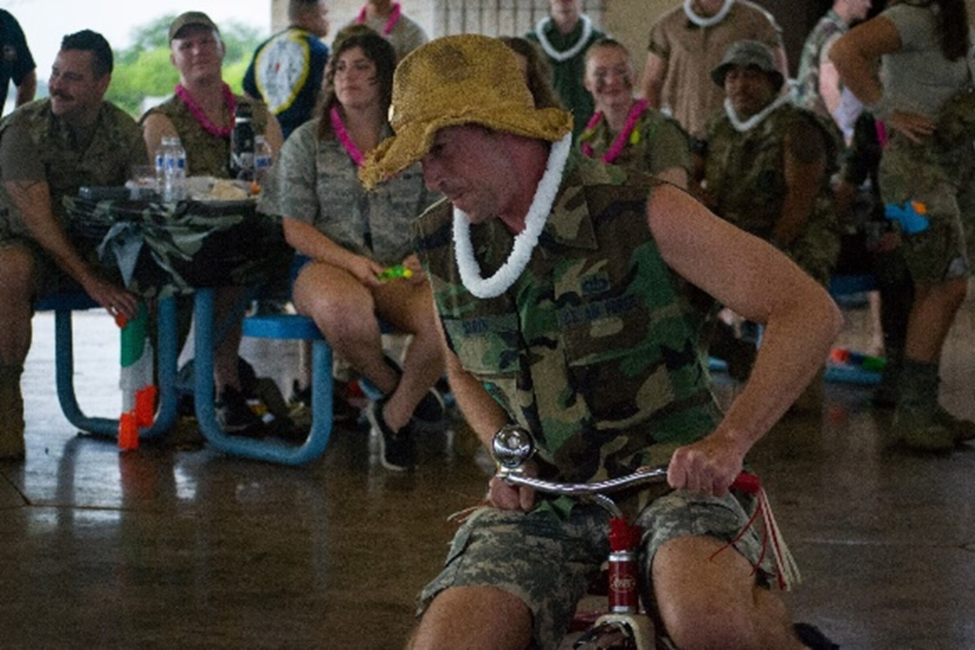 Maj. Brian S. Smith, Director of Operations, completes an obstacle course on a tricycle enroute to the nonalcoholic grog bowl during a Combat Dining-In on Sept. 16 at Hickam Air Force Base, Hawaii.