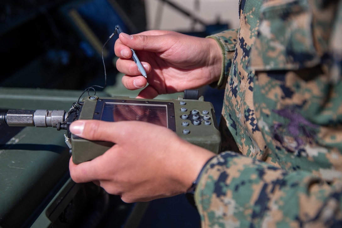 U.S. Marine Corps Lance Cpl. Marvin Diaz, a satellite communications operator with 9th Communication Battalion, I Marine Expeditionary Force Information Group, loads crypto on the PYQ-10 Simple Key Loader at Marine Corps Base Camp Pendleton, California, March 11, 2022. This training allows the 9th Communication Battalion to be capable of operating, defending, and preserving information networks to enable command and control for the commander in all domains, and support and conduct Marine Air Ground Task Force operations in the information environment. (U.S. Marine Corps photo by Cpl. Alize Sotelo)