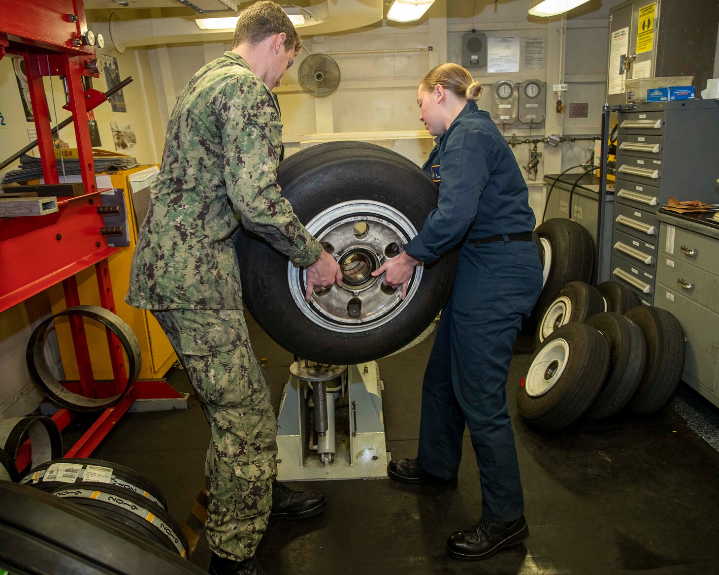 Aviation Structural Mechanic Airman Keldon Haselden from, Johnsonville, South Carolina, and Aviation Structural Mechanic Airman Sydney Powell, from Eastman, Georgia, both assigned to the first-in-class aircraft carrier USS Gerald R. Ford’s (CVN 78) aircraft intermediate maintenance department, performs routine maintenance, Oct. 8, 2022