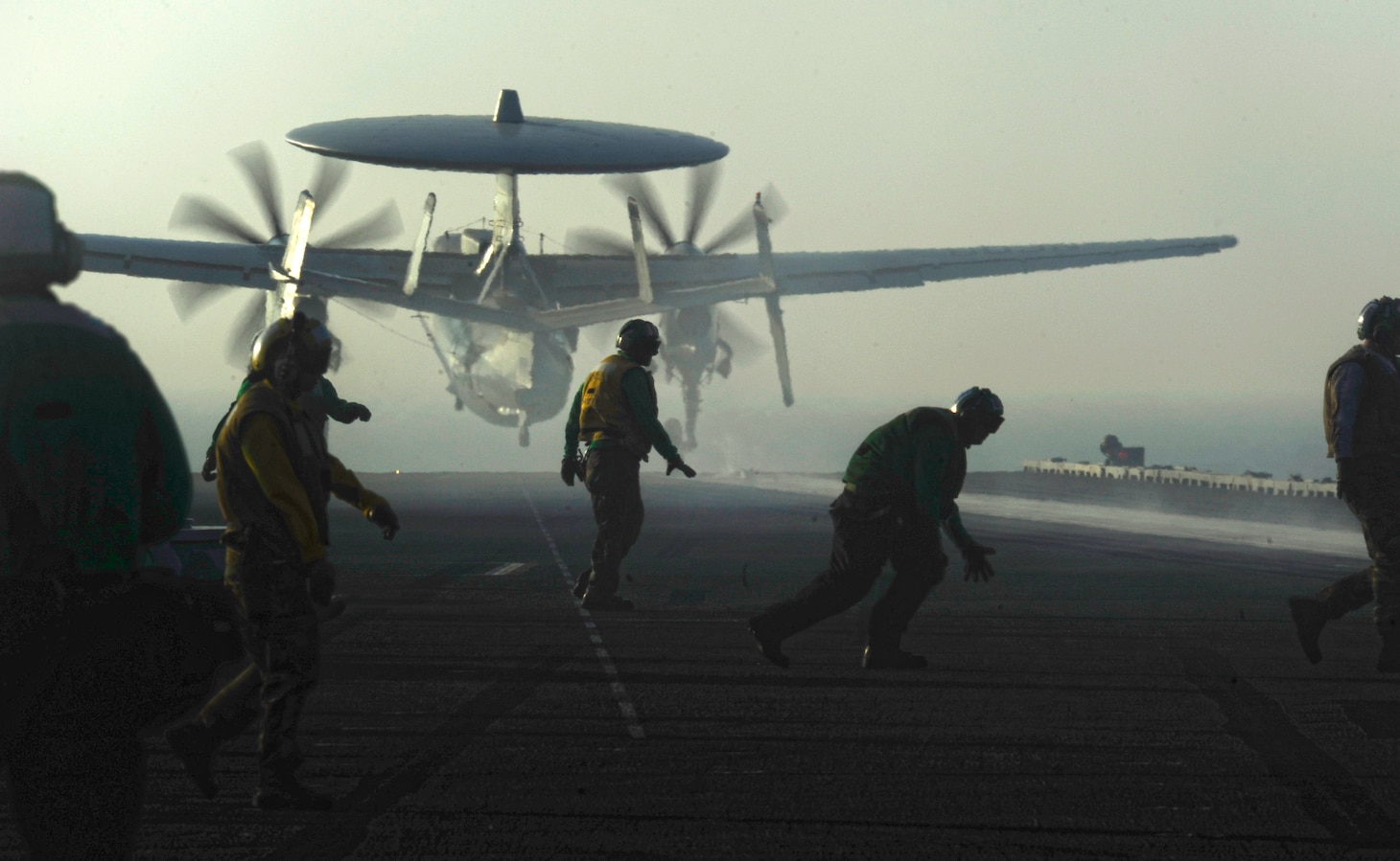 Aviation boatswain's mates recover after launching an E-2C Hawkeye assigned to the Golden Hawks of Airborne Early Warning Squadron (VAW) 112 during flight operations aboard the aircraft carrier USS John C. Stennis (CVN 74). John C. Stennis was deployed to the U.S. 5th Fleet area of responsibility conducting maritime security operations and support missions as part of Operations Enduring Freedom and New Dawn.