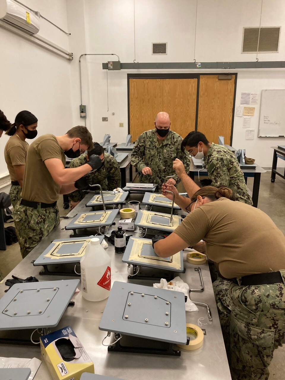 AME1 David Mcmenamy trains Sailors on the proper Form In Place application.