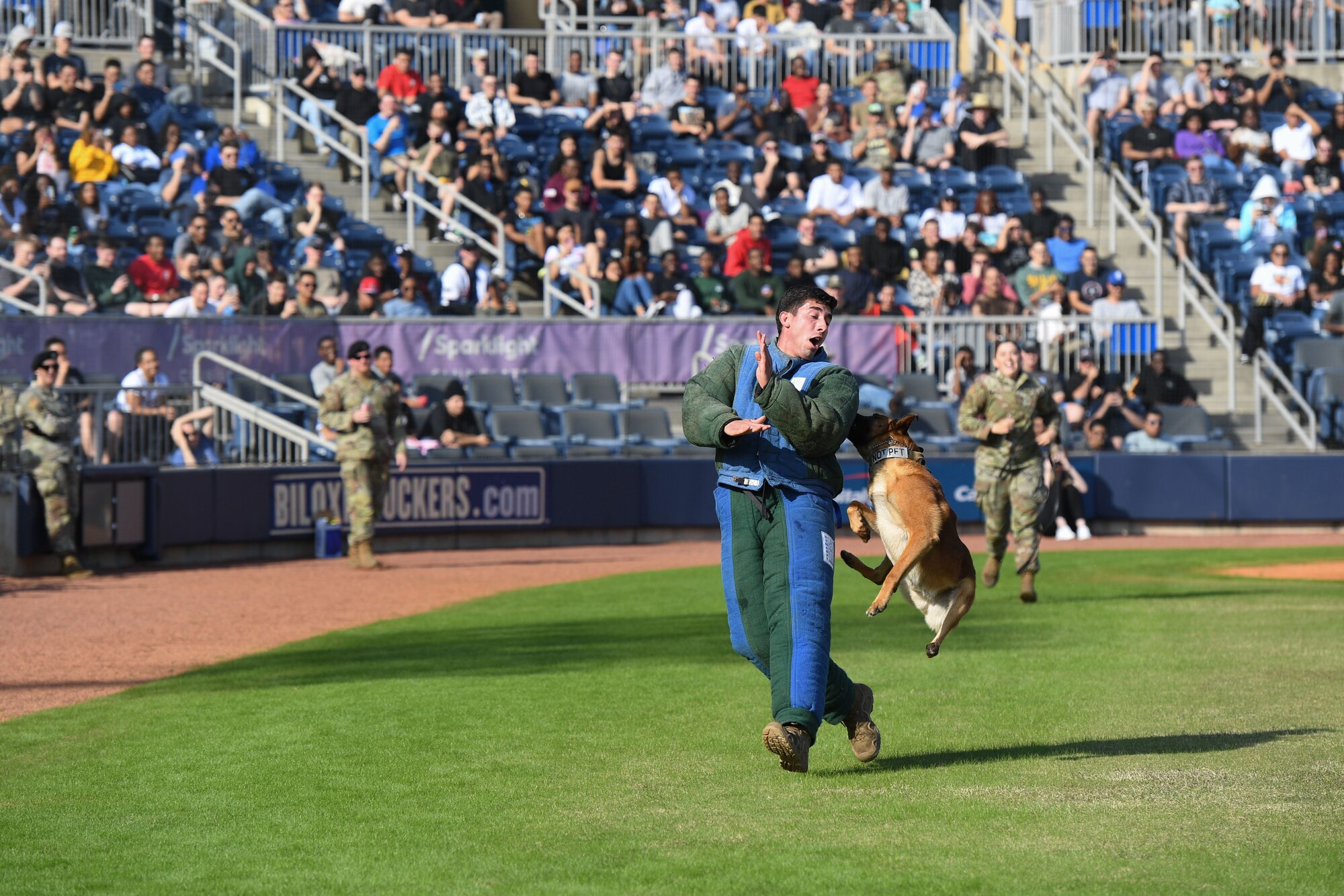 U.S. Air Force Staff Sgt. Anthony Seretis, 81st Security Forces Squadron military working dog handler, and Victor, 81st SFS military working dog, participate in a demonstration at MGM Park in Biloxi, Mississippi, Dec. 5, 2022.