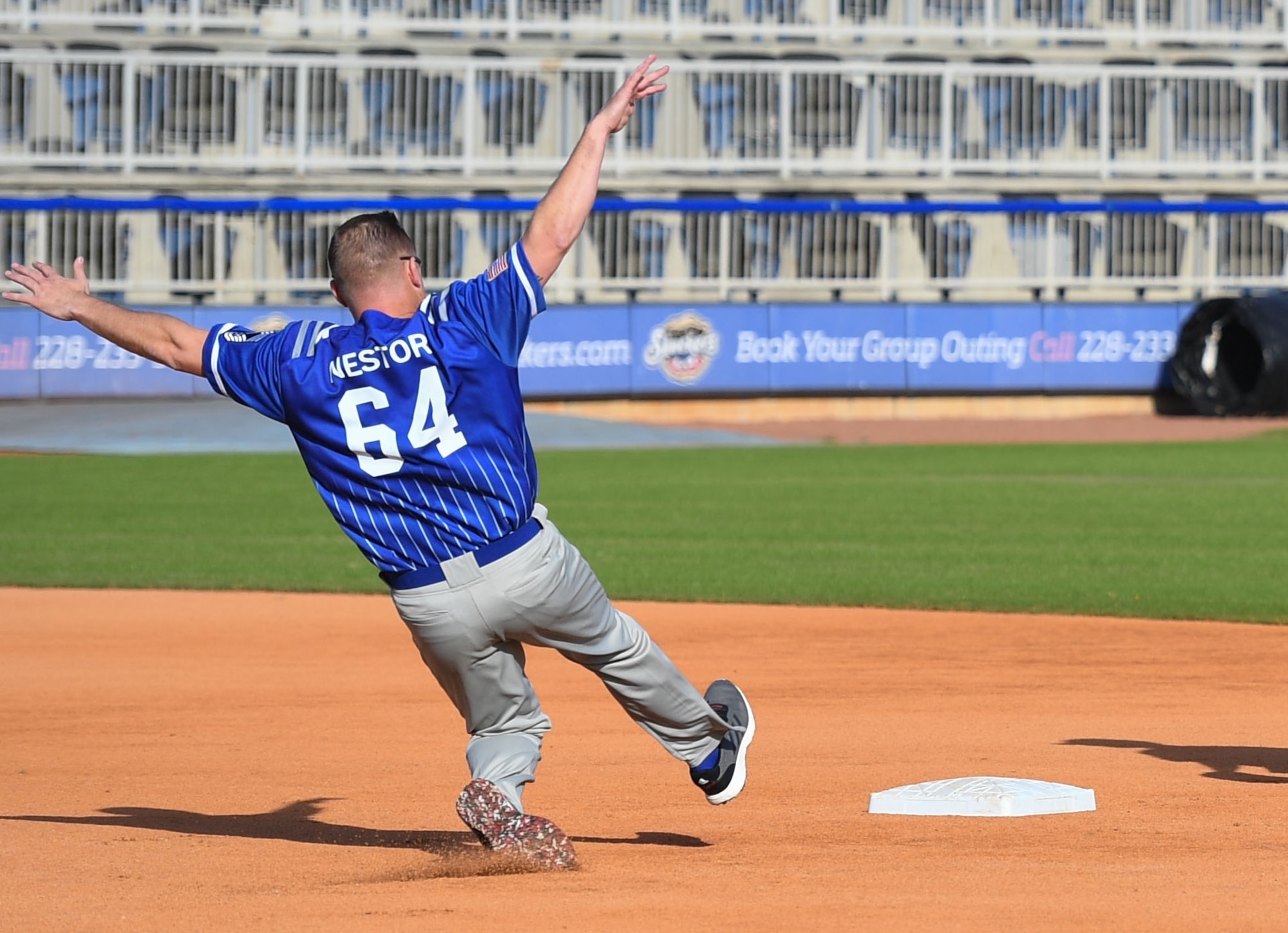 U.S. Air Force Chief Master Sgt. Daniel Nestor, Second Air Force special warfare training pipeline manager, slides into second base during the 2nd Annual Chiefs vs. Eagles softball game at MGM Park in Biloxi, Mississippi, Dec. 5, 2022.