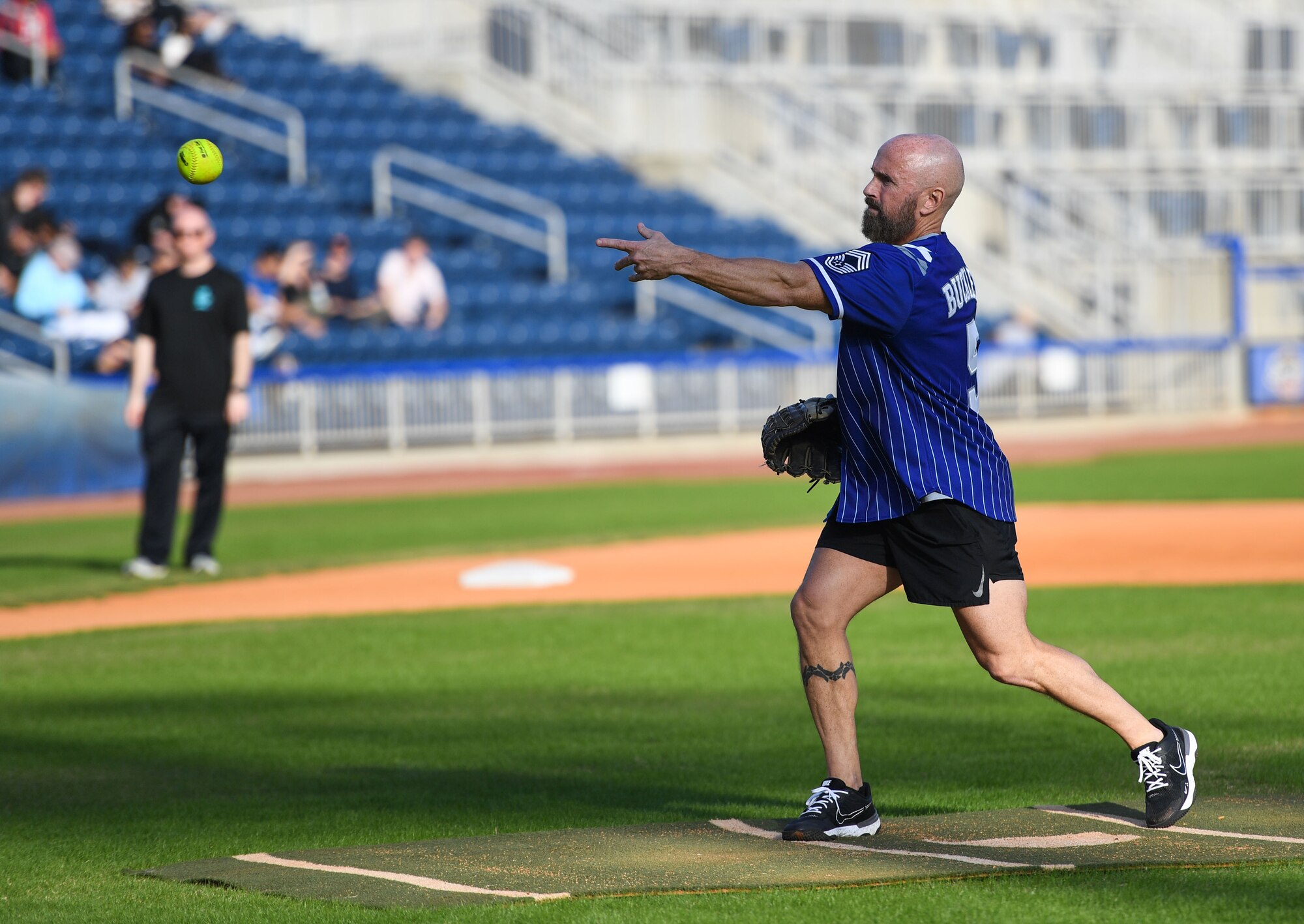 Retired U.S. Air Force Chief Master Sgt. Jason Buckley pitches a softball during the 2nd Annual Chiefs vs. Eagles softball game at MGM Park in Biloxi, Mississippi, Dec. 5, 2022.
