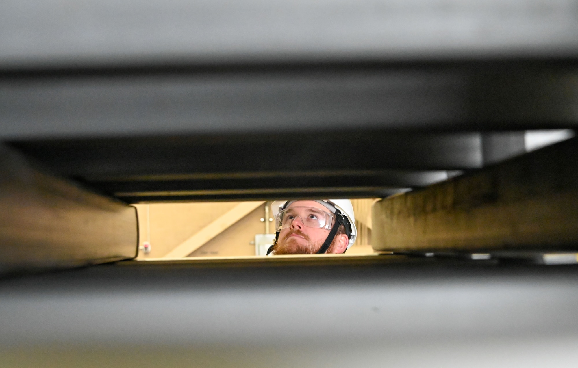 James Atwell, 97th Maintenance Squadron aircraft mechanic, watches as the balloons inflate on top of new cribbing at Altus Air Force Base, Oklahoma, Dec. 7, 2022. The process that includes the cribbing is a part of the Crashed Disabled Damaged Aircraft Recovery Program. (U.S. Air Force photo by Senior Airman Kayla Christenson)