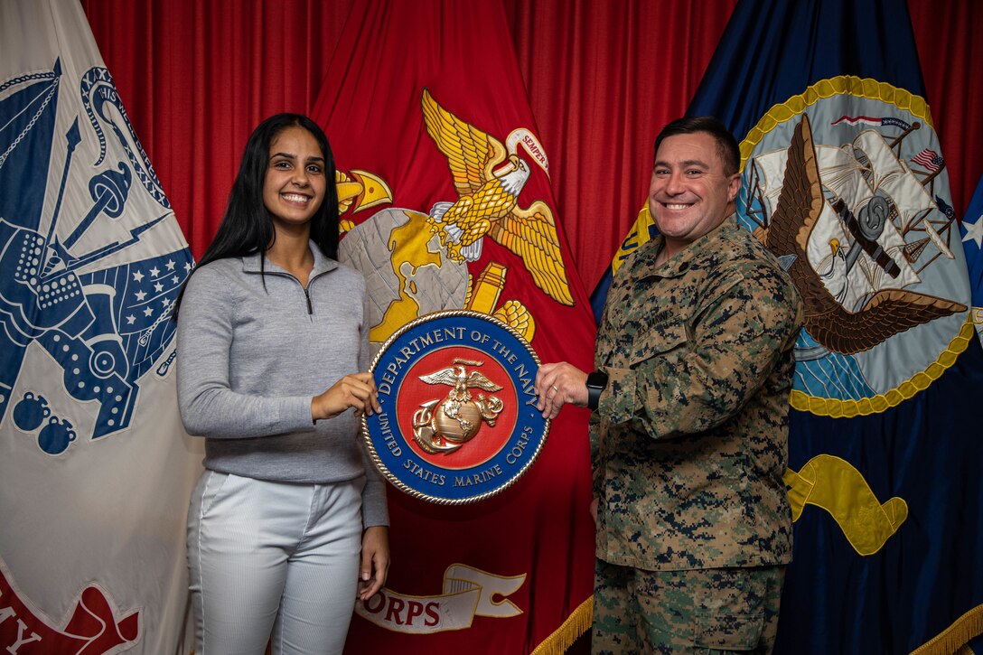 U.S. Marine Corps GySgt. James Hopper, a Military Entrance Processing Station Liason with Recruiting Station Lansing and Poolee Deborah Cardosocarvalho pose for a photo on November 10, 2022 in Lansing, MI. Cardosocarvalho has been preparing to enlist in the United States Marine Corps since May of 2021. She wanted to join the Marine Corps and enlisted into the Infantry military occupational specialty field because she wanted to be a part of something larger than herself, and join the hardest branch to challenge both her physical and mental limits. Cardosocarvalho leaves for bootcamp on Marine Corps Recruit Depot Parris Island, S.C. on the 28th of November. (U.S. Marine Corps photo by Sgt. Jesse K. Carter-Powell)