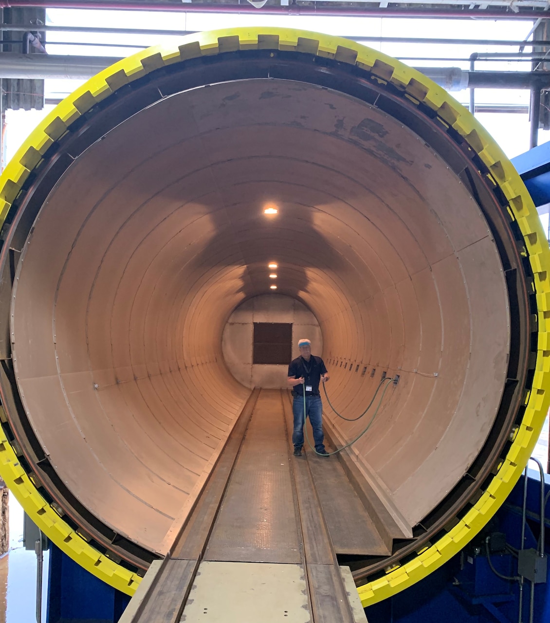 An Amfuel employee stands inside the new large autoclave purchased as Government Furnished Equipment and used in the production of CH-53K fuel cells.