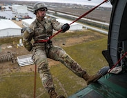 A soldier in the 101st Airborne Division (Air Assault) prepares to rappel downward during Air Assault School Phase Three in Mihail Kogalniceanu Airbase, Romania, on November 29, 2022. Helicopter rappelling is one of the last events required to graduate Air Assault School. (U.S. Army photo by Pfc. Matthew Wantroba)