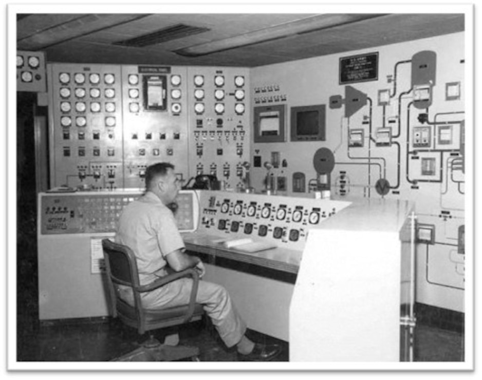 Man sitting at control room desk in the SM-1 building.