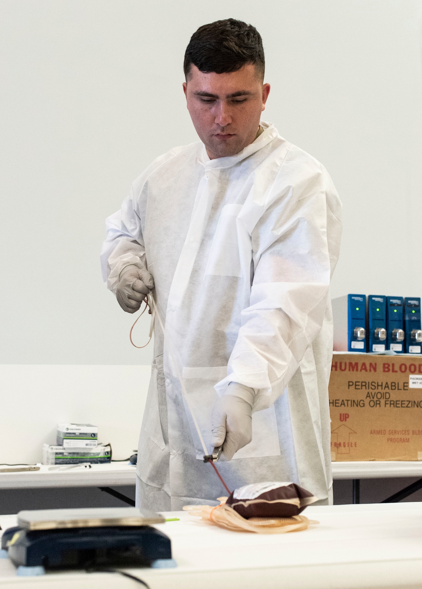 U.S. Army Spc. Derek Lewis, Fort Bragg Blood Donor Center medical laboratory specialist, prepares donated blood for processing during an Armed Services Blood Program blood drive held at The Landings on Dover Air Force Base, Delaware, Dec. 6, 2022. Lewis and other team members from the Fort Bragg BDC in North Carolina, traveled to Dover AFB to support the ASBP blood drive. (U.S. Air Force photo by Roland Balik)