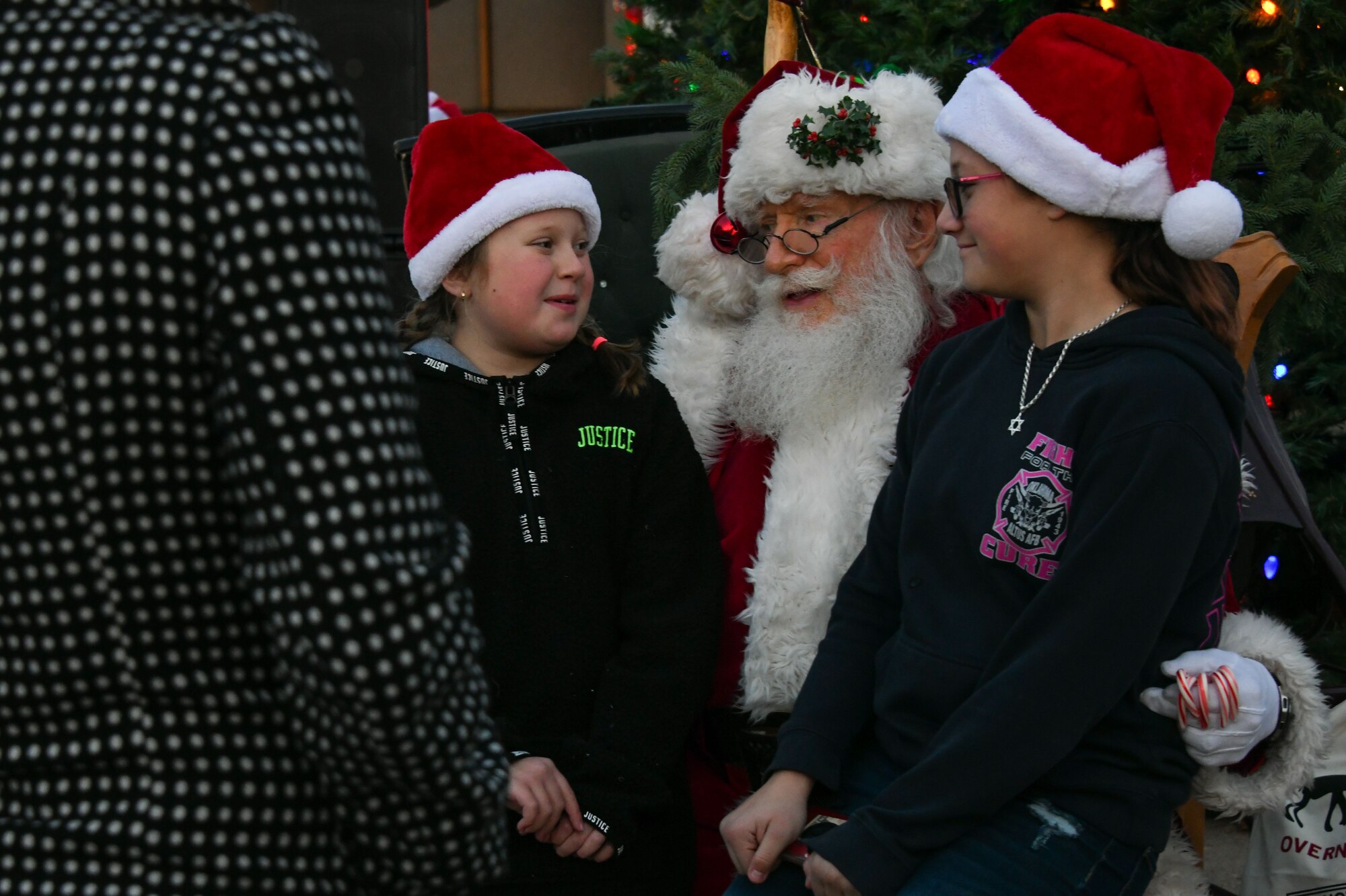 Children from the 97th Air Mobility Wing sit on Santa’s lap at Altus Air Force Base, Oklahoma, Dec. 6, 2022. More than 100 children lined up to take pictures with Santa Claus. (U.S. Air Force photo by Airman 1st Class Miyah Gray)