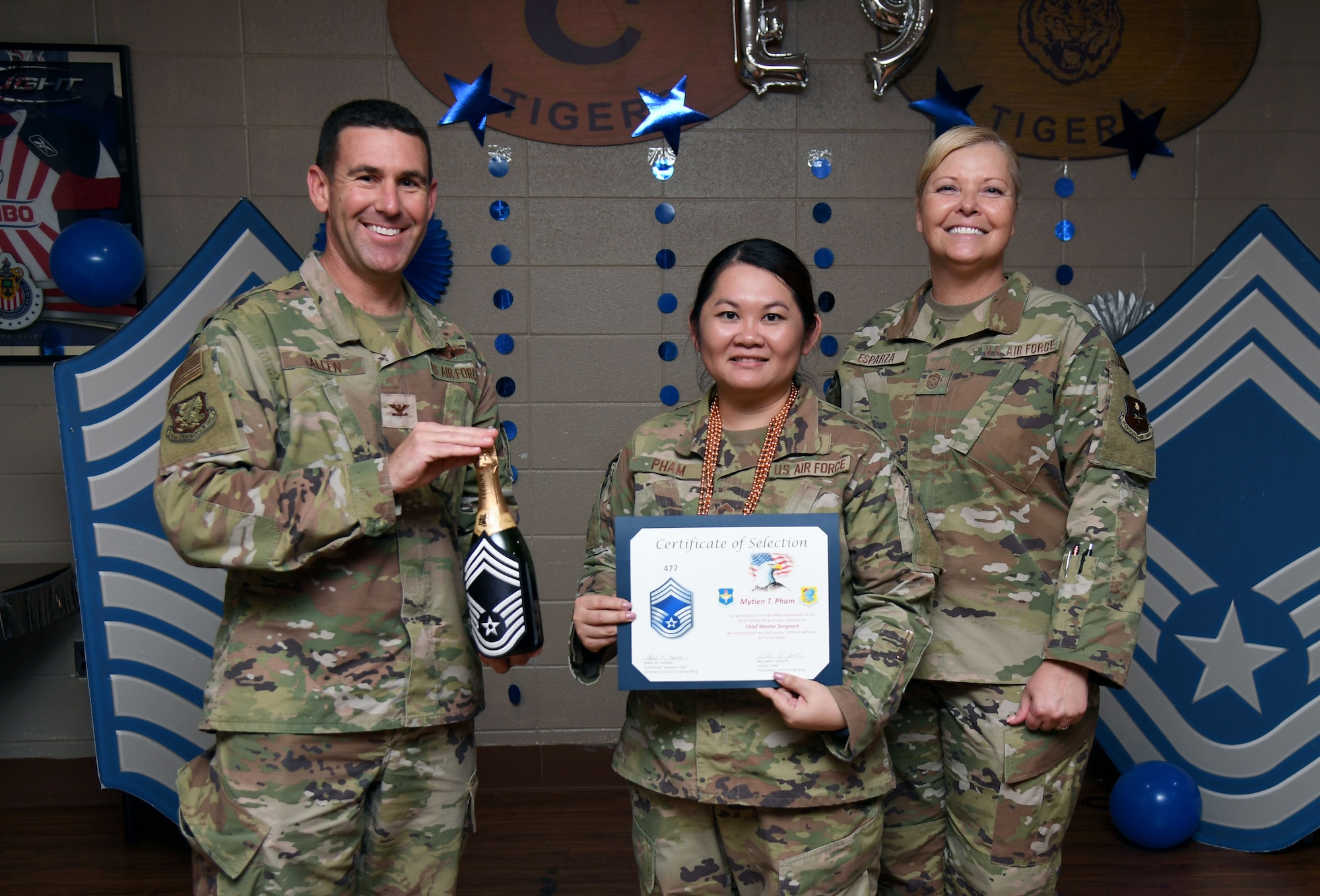 U.S. Air Force Col. Jason Allen, 81st Training Wing vice commander, and Chief Master Sgt. Sarah Esparza, 81st TRW command chief, congratulate Senior Master Sgt. Mytien Pham, 81st Medical Support Squadron senior enlisted leader, on her promotion to chief master sergeant during the chief master sergeant release ceremony inside Gaude Lanes at Keesler Air Force Base, Mississippi, Dec. 6, 2022.