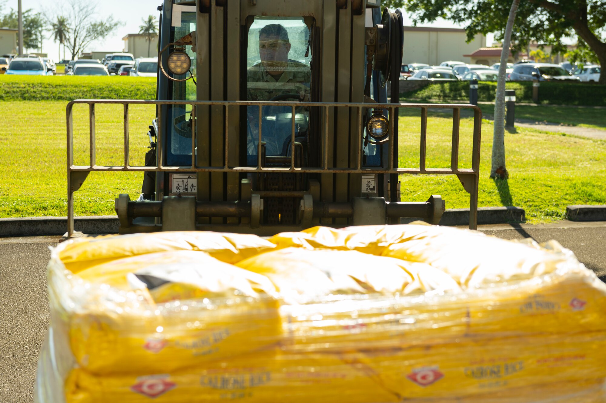U.S. Air Force Tech. Sgt. Charles Hall, noncommissioned officer in charge of ground transportation training assigned to the 36th Logistics Readiness Squadron, uses a 10K 463L forklift to move pallets of rice on Andersen Air Force Base, Guam, Dec. 1, 2022. Members of the ground transportation team moved about 50,000 pounds of cargo in support of the 71st Operation Christmas Drop. (U.S. Air Force photo by Airman Spencer Perkins)